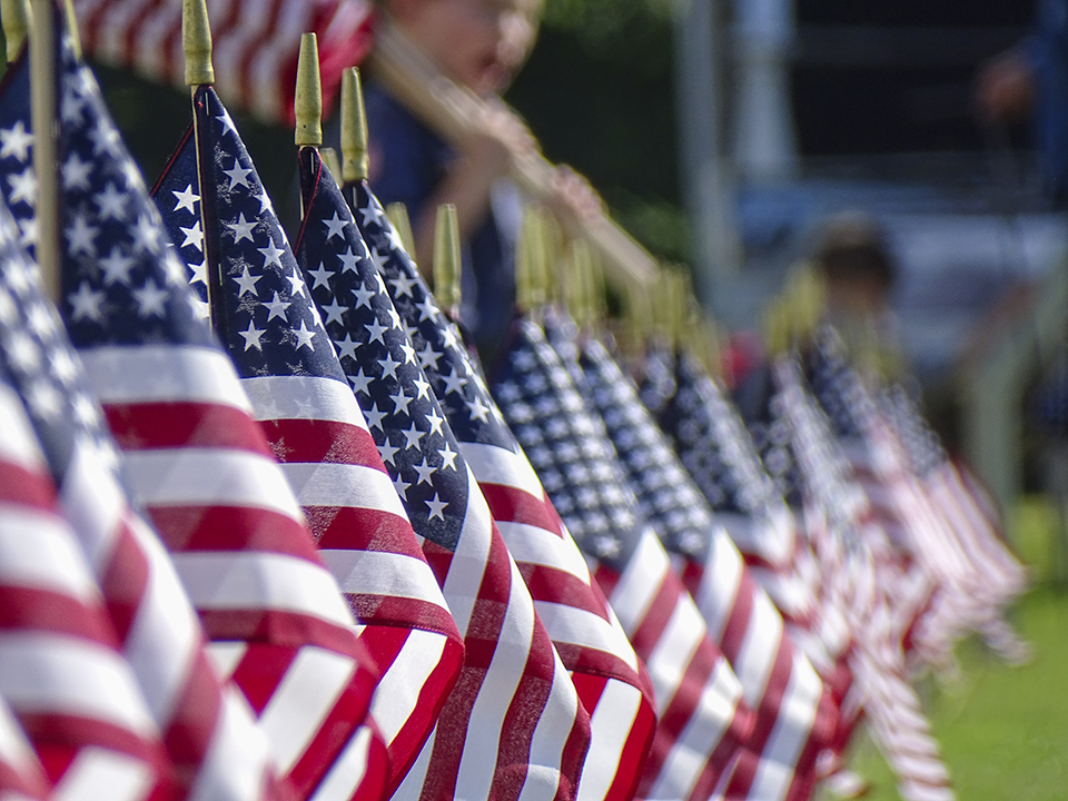 Line of American flags on the Symbols of Sacrifice "Field of Honor". Closeup of a line of miniature American flags on the Symbols of Sacrifice "Field of Honor".