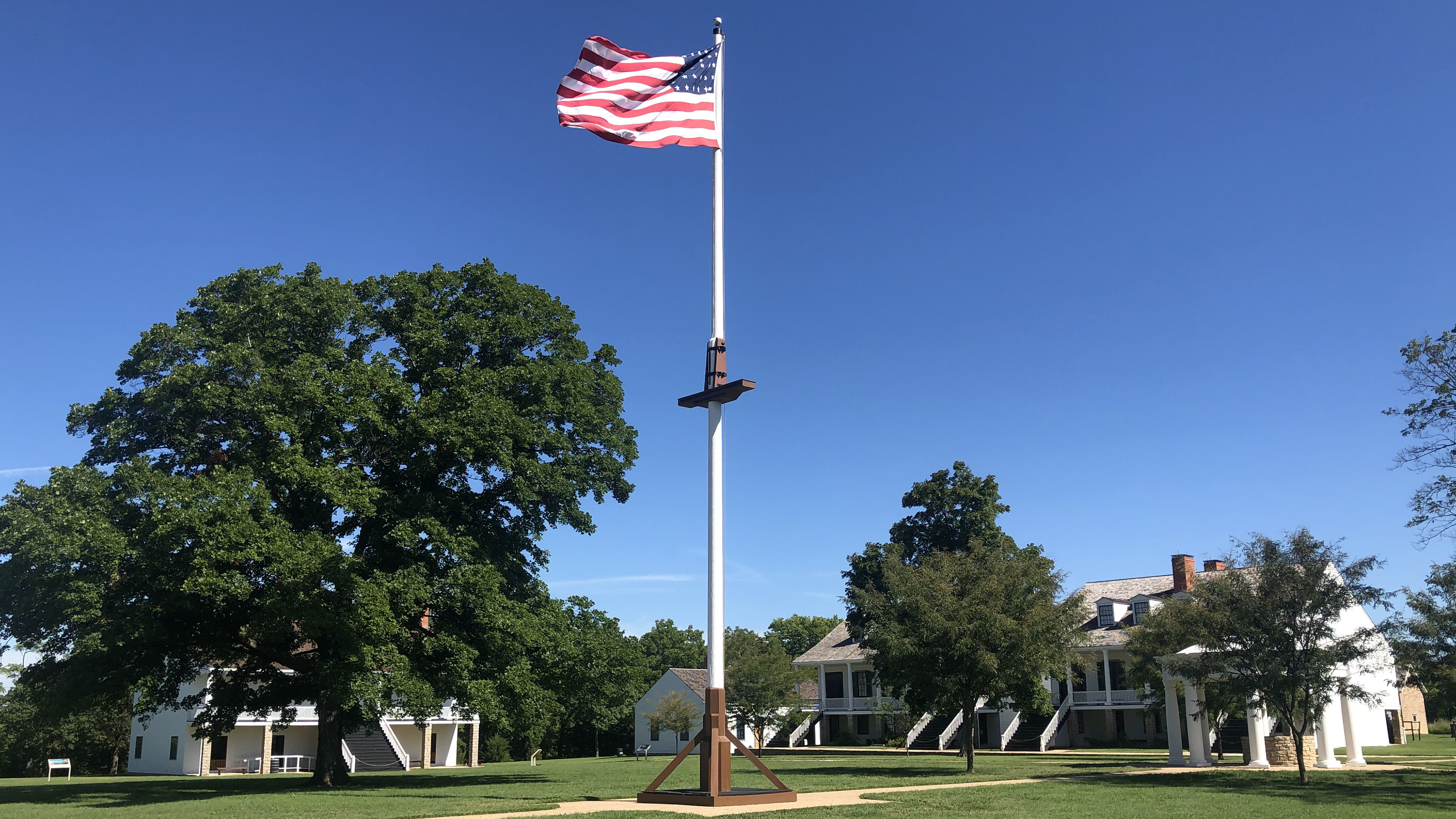 30 star flag on parade ground in front of white historic buildings. 30 star flag on parade ground in front of white historic buildings.