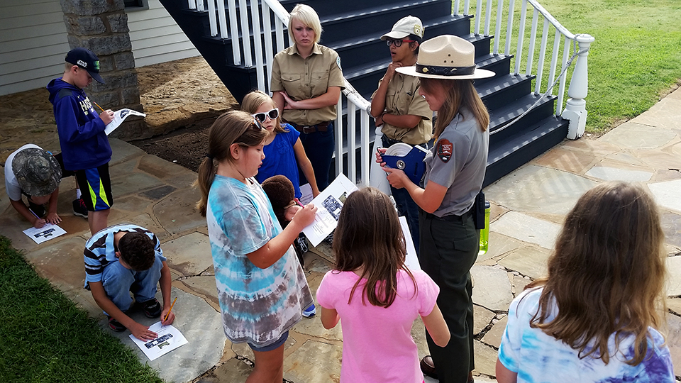 Intern teaching summer program near barracks stairs. Intern teaching summer program near barracks stairs.