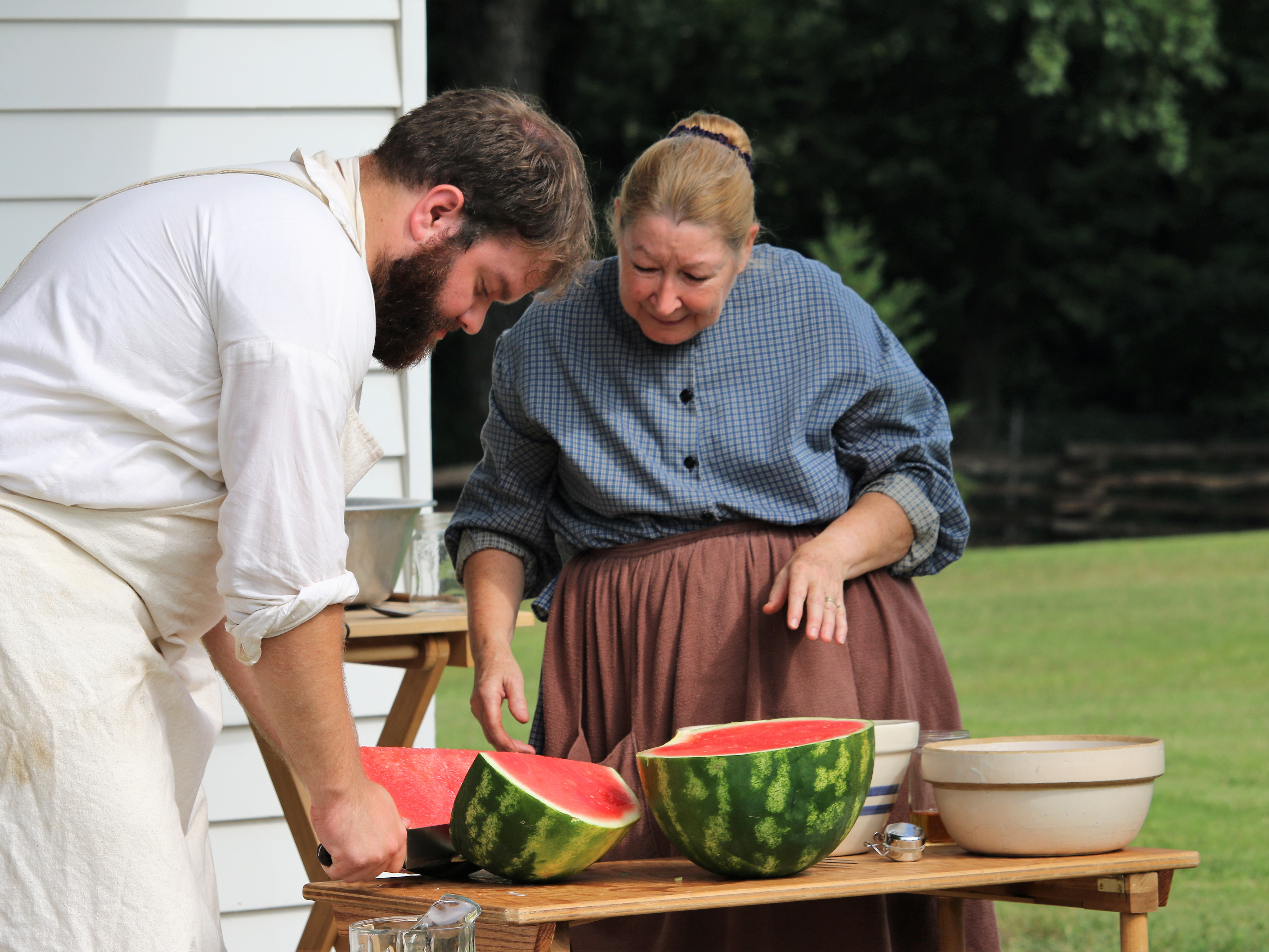 A soldier and laundress preparing watermelon