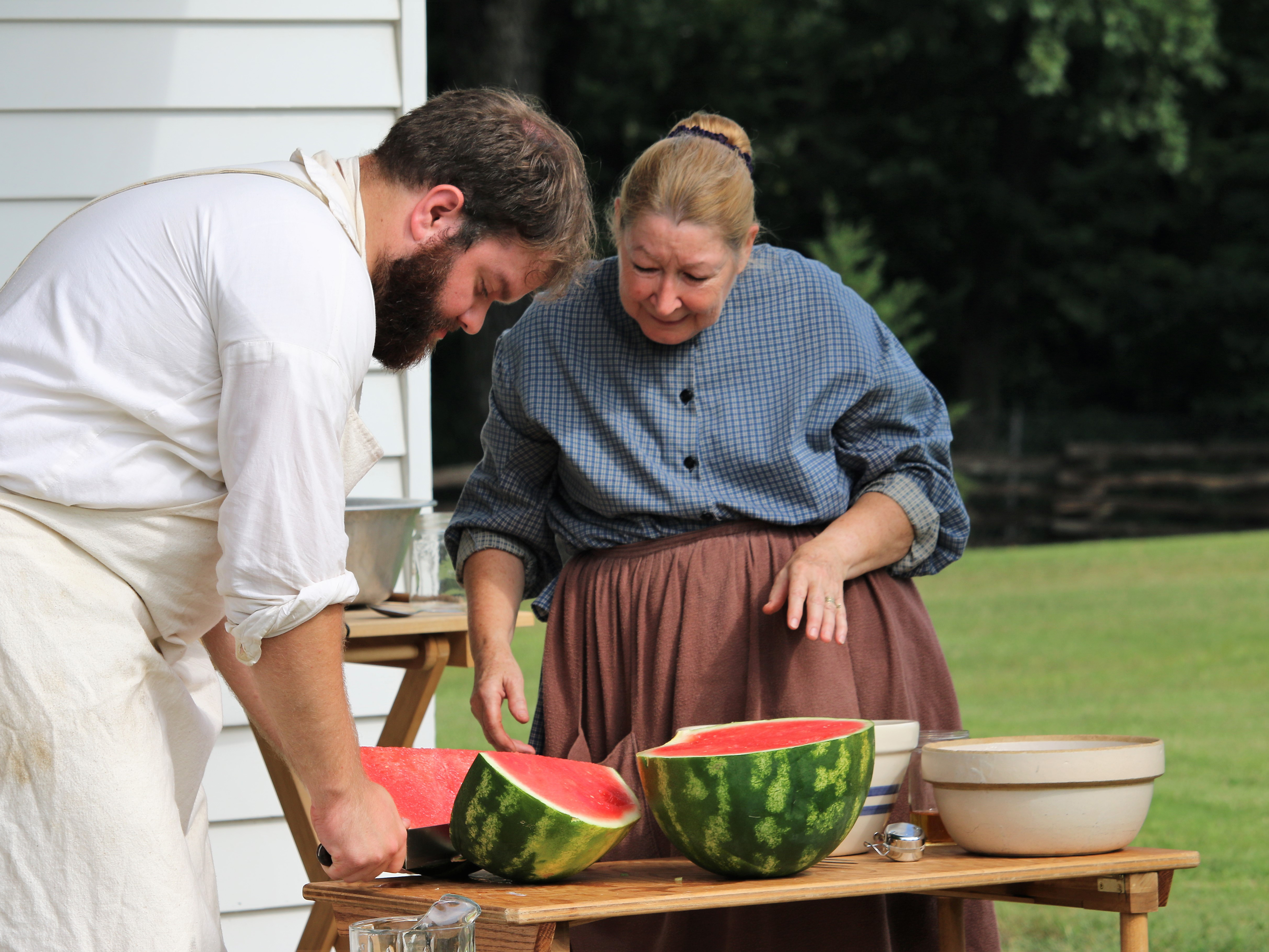 A soldier and laundress preparing watermelon A soldier and laundress preparing watermelon