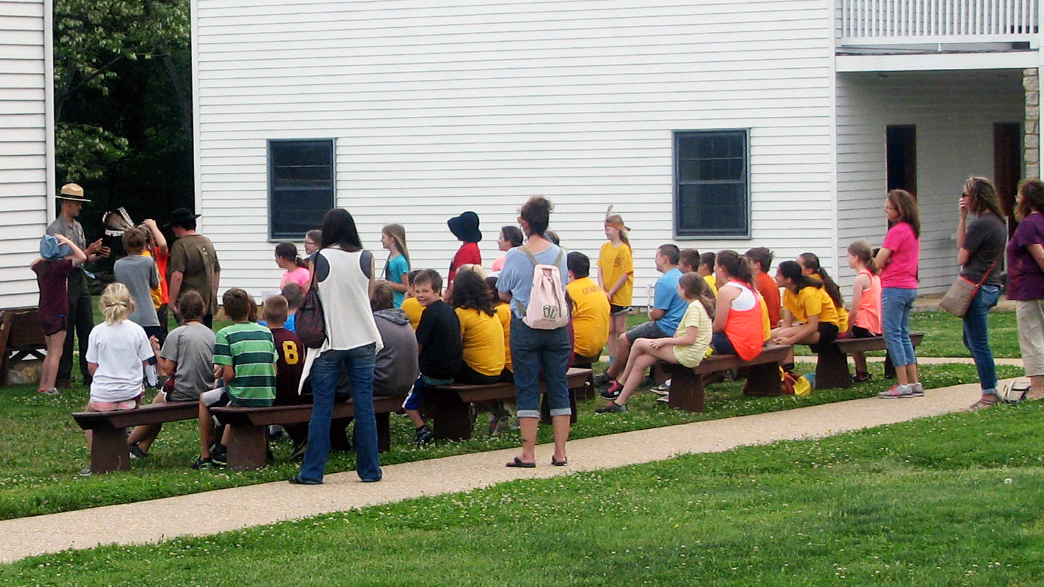 A group of students and teachers watch a ranger program A group of students and teachers watch a ranger program