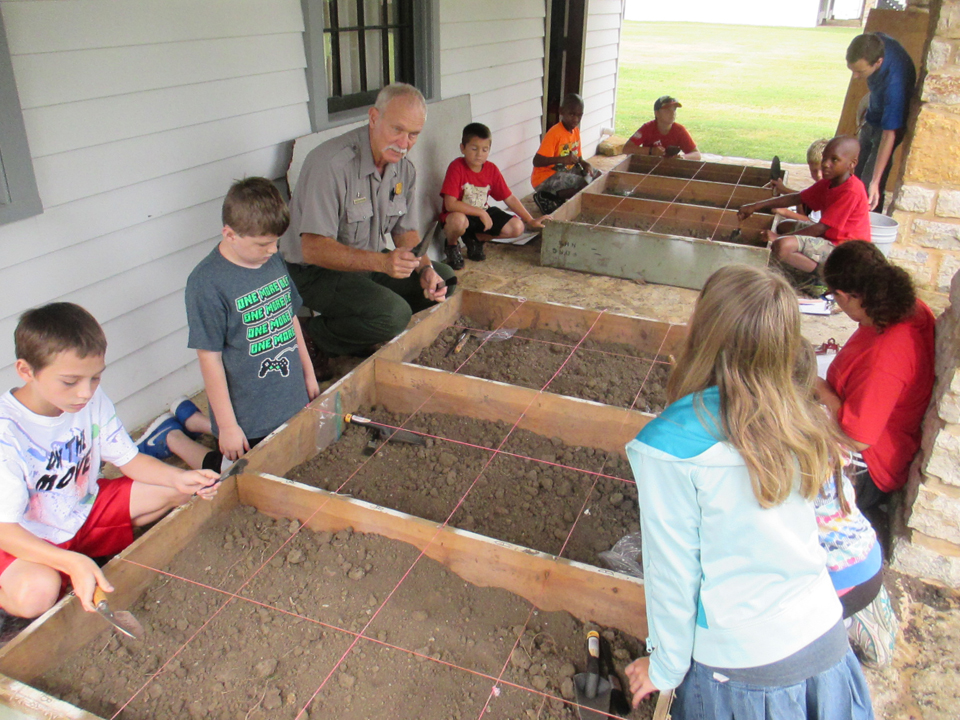 youth digging in dirt