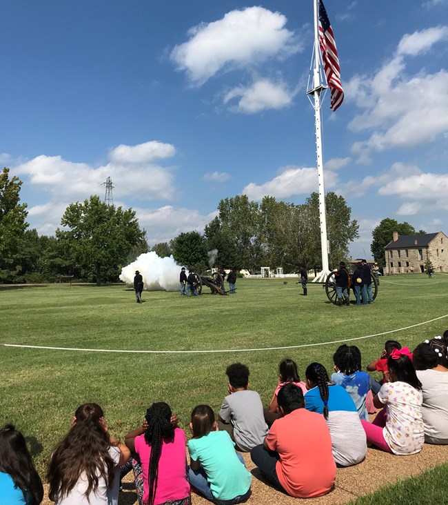 Students watching a cannon demonstration on the Fort Smith NHS Parade Ground.