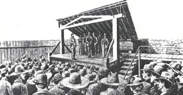 drawing of execution of Cherokee Bill showing large crowd gathered around gallows structure. Cherokee Bill is standing on scaffold with a rope hanging from the cross beam. Standing in the distance on the scaffold is a woman, Cherokee Bill's mother. drawing of execution of Cherokee Bill showing large crowd gathered around gallows structure. Cherokee Bill is standing on scaffold with a rope hanging from the cross beam. Standing in the distance on the scaffold is a woman, Cherokee Bill's mother.