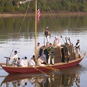 reconstructed keelboat on the Arkansas River with people dressed as soldiers from 1817