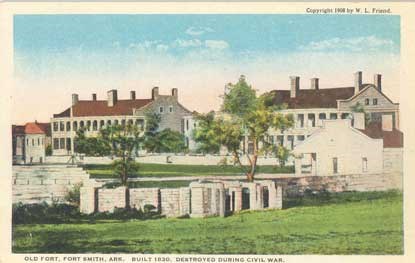 postcard of fort with walls and guardhouse in foreground, officers quarters in background