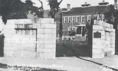 swing set on lawn in front of former courthouse with Memorial Gateway in foreground