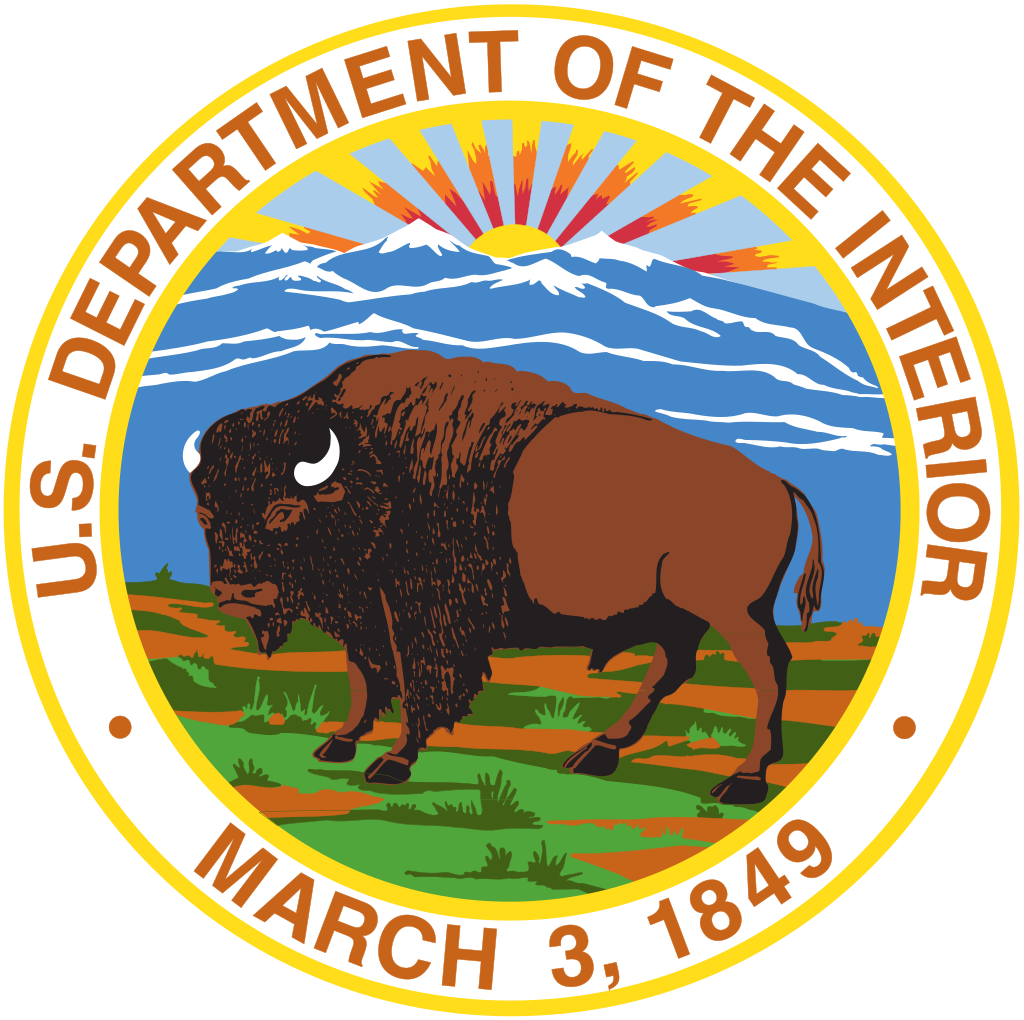 A circular seal with a bison in the center and rays of sun behind the bison. A circular seal with a bison in the center and rays of sun behind the bison.