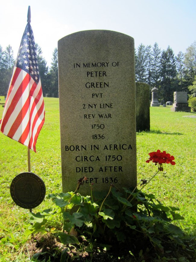 A marble headstone, well taken care of. On top is written "In Memory of Peter Green Pvt 2nd NY Line Rev War"