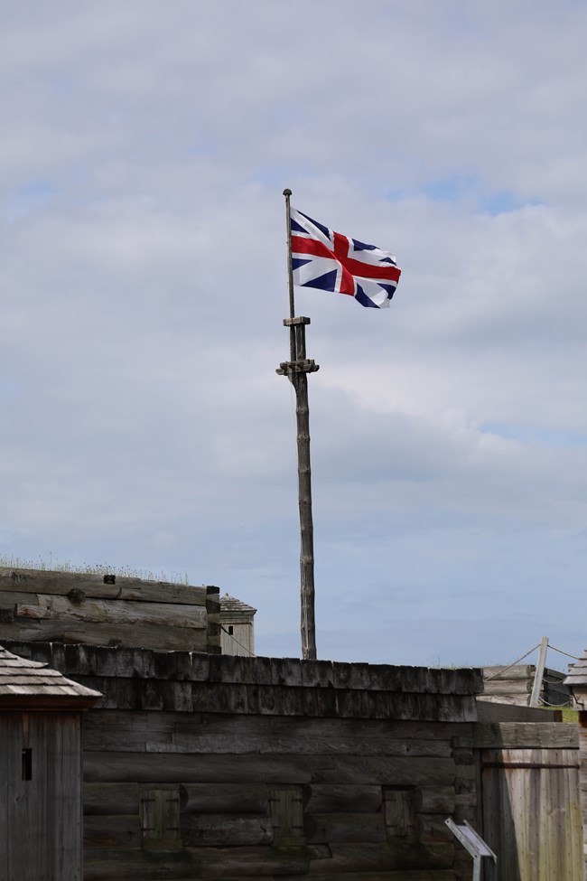 A British Union Jack-style flag flaps over the fort wall.
