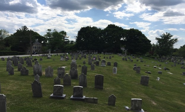 A old graveyard with deteriorating headstones. 