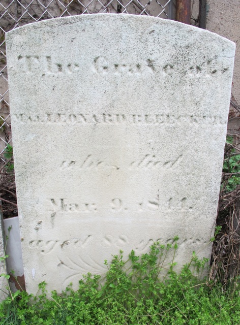 A white marble stone with the name 