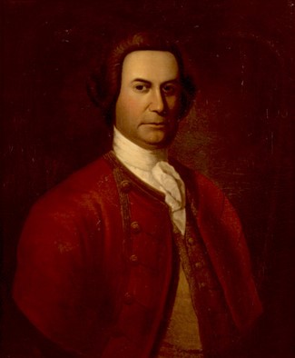 BlogPictureJJ4 Johnson has a broad-shouldered down and stocky build. He wears dark brown wig, a white shirt and cravat and a dark red coat with large gold buttons and gold trim on the lapels.