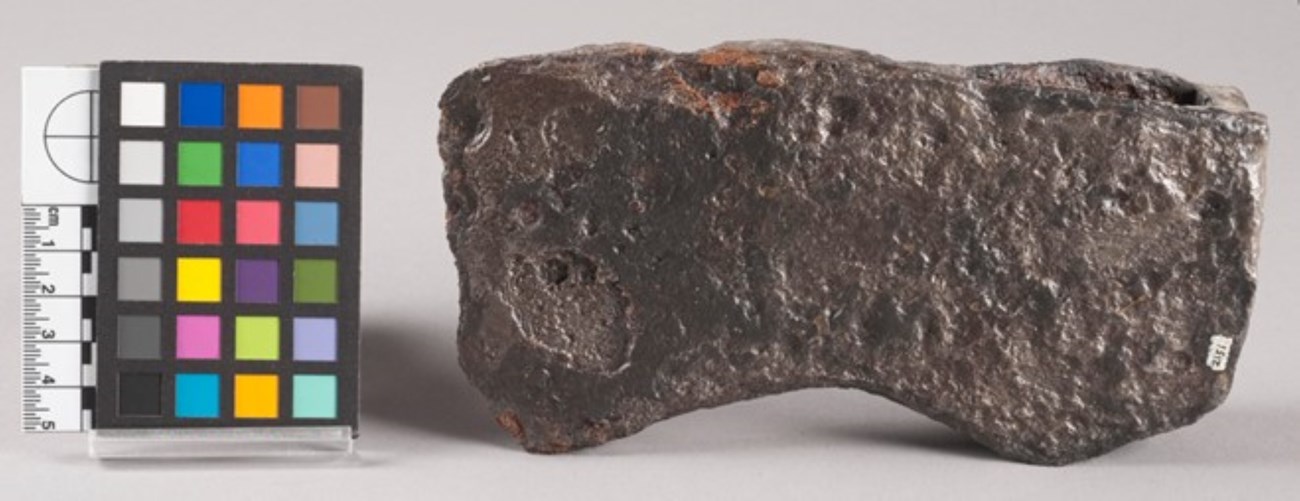 A pitted hunk of metal, shaped like a block of cheese.