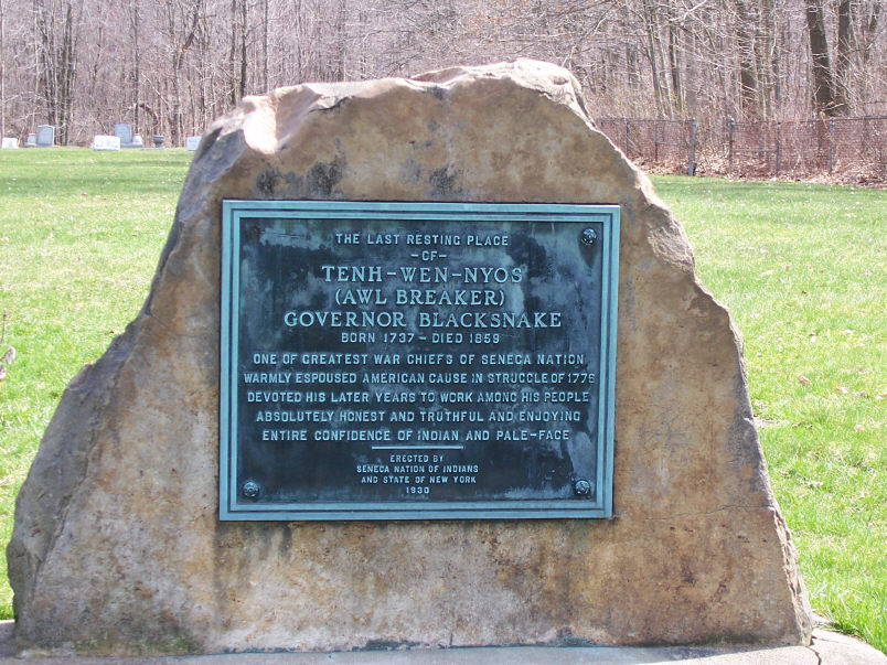 A large stone in the middle of an open field. A plaque on it says it's the last resting place of Chainbreaker. 