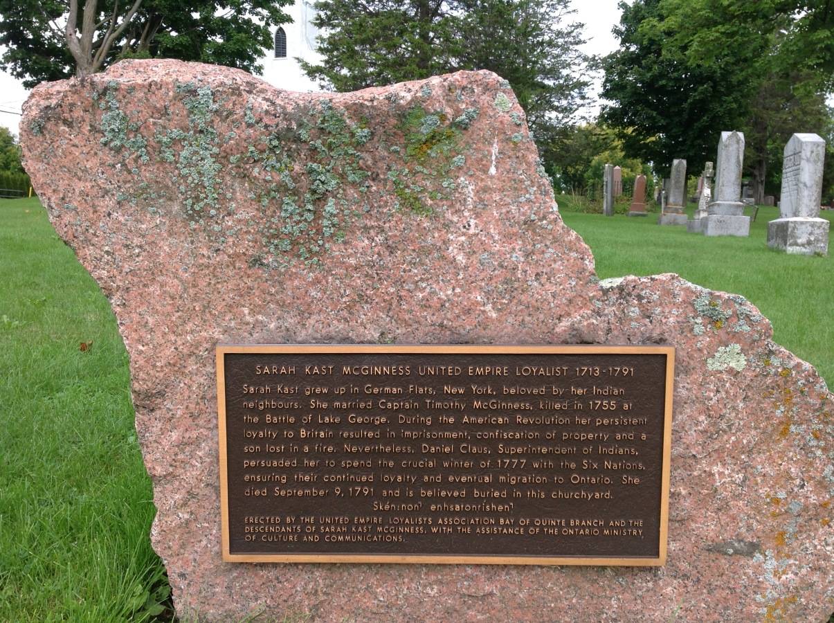 Kast-Memorial-HQ A large stone with a plaque on it dedicated to Sarah Kast McGinnis.
