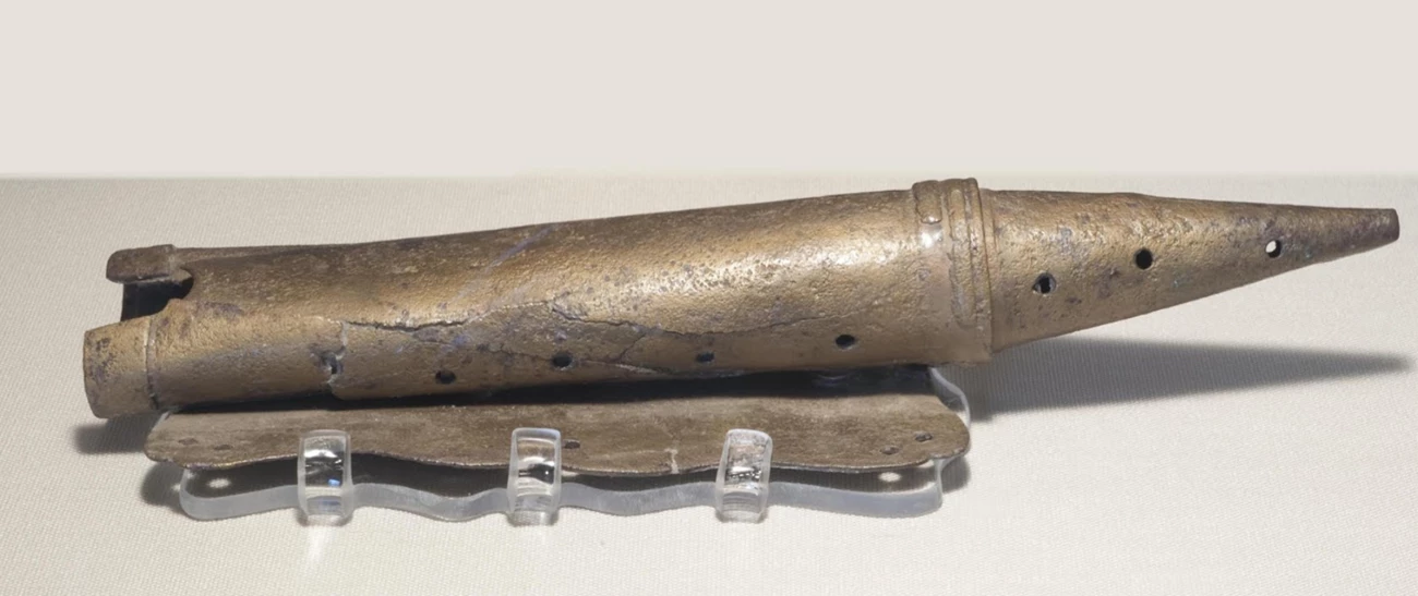 MatchCaseFOST A slightly squished metal tube with holes in it and a pointed end.