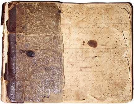 A rectangular old, yellowing book with corners torn and pages chewed along the edges.
