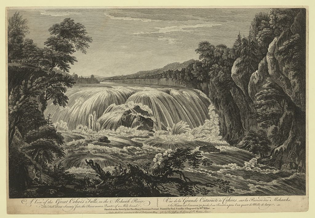 A low waterfall/rapids area flows through a rocky area of a river.