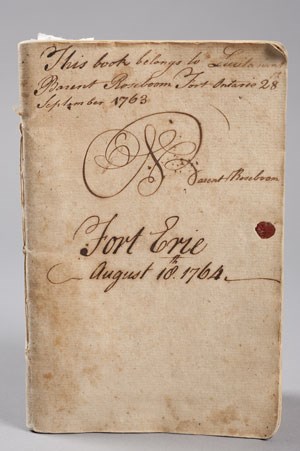 An old hand-bound book with faded ink and handwriting on the front.