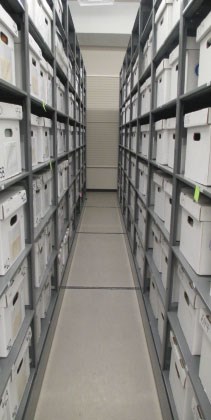 Compact shelving contains numerous boxes inside collection storage. Compact shelving contains numerous boxes inside collection storage.