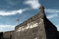 a large grey stone wall rises in your path.