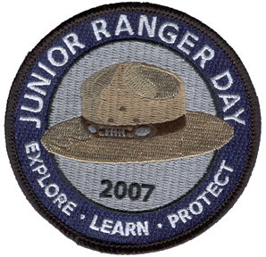 a blue circle surrounds a brown felt hat, words circle: