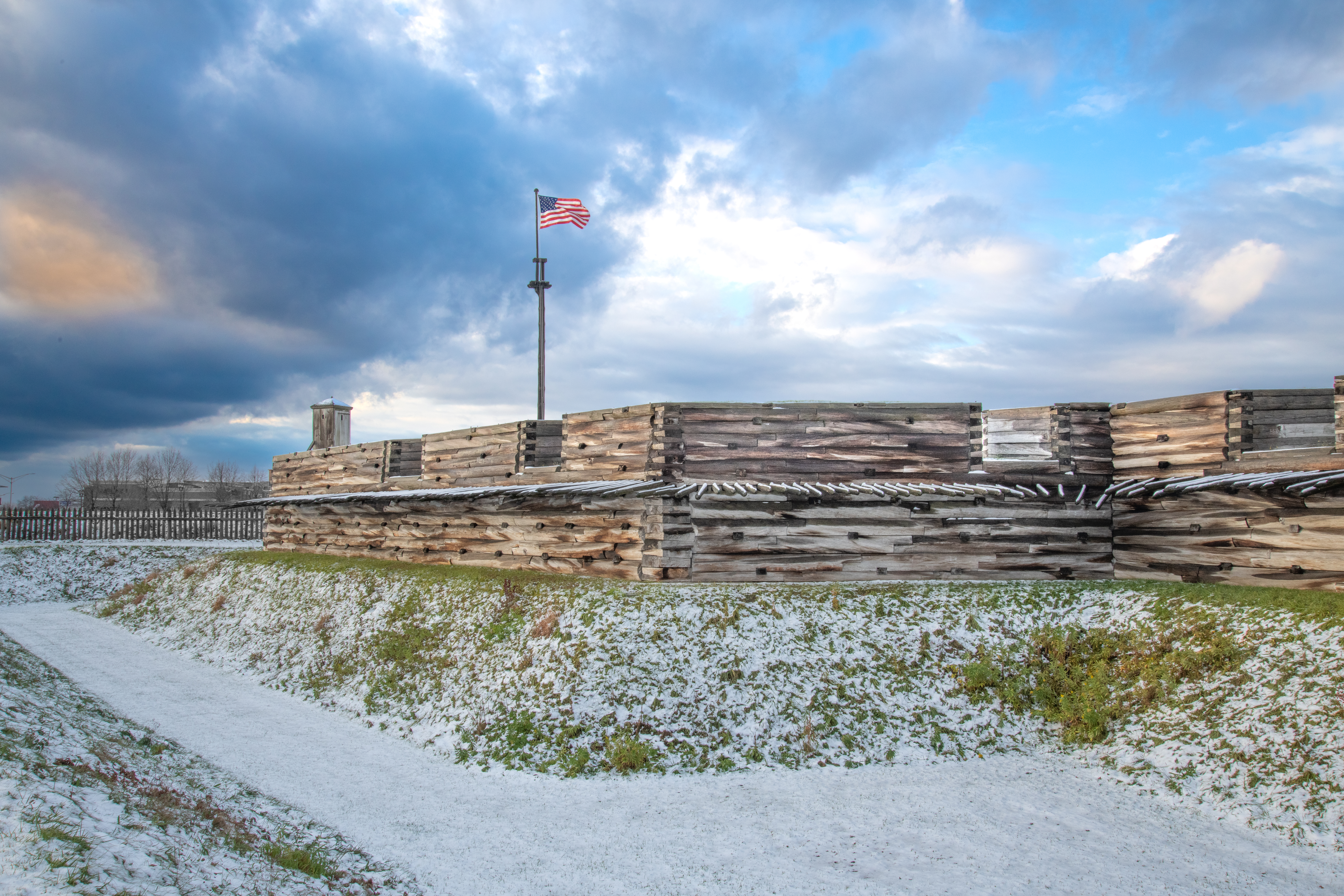 D85_9858 Shadows begin to set on the wooden fort, covering the bright snow with dark strips.