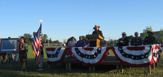 a bandstand at sunset, many officials in uniform