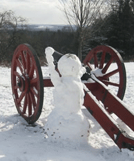 a robust snow man holds his arm up while gadging a target for his cannon