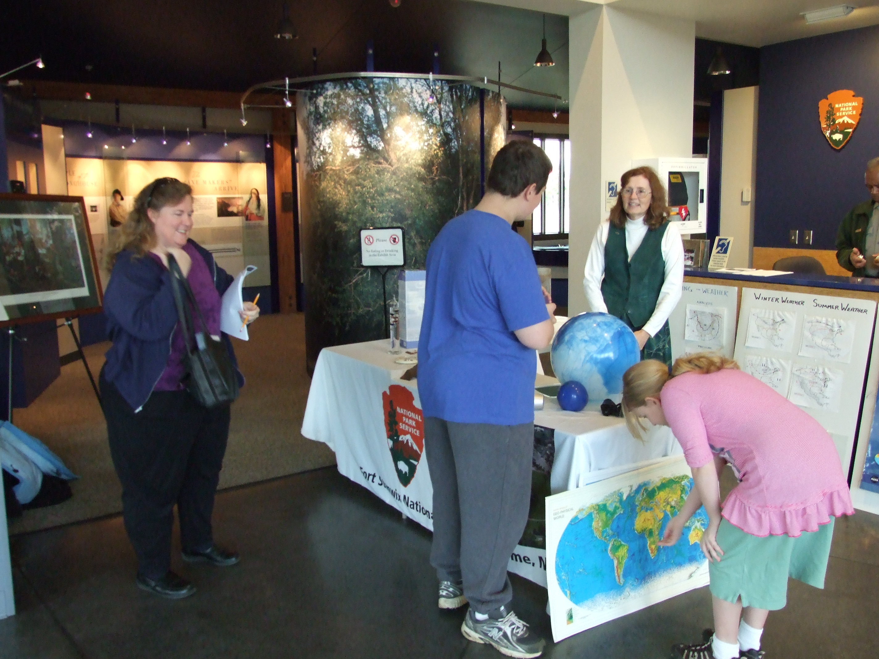 children look through tools and odd shaped devices on a table