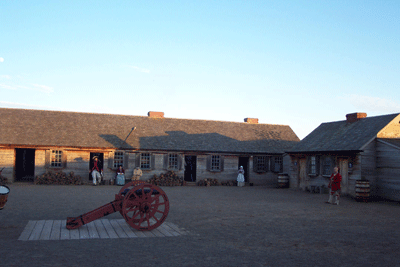 sunset on the parade ground, people gather around a cannon and tell stories