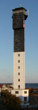 A three-sided black-and-white lighthouse.