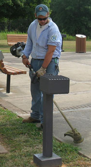 A YCC youth works on grounds maintenance.