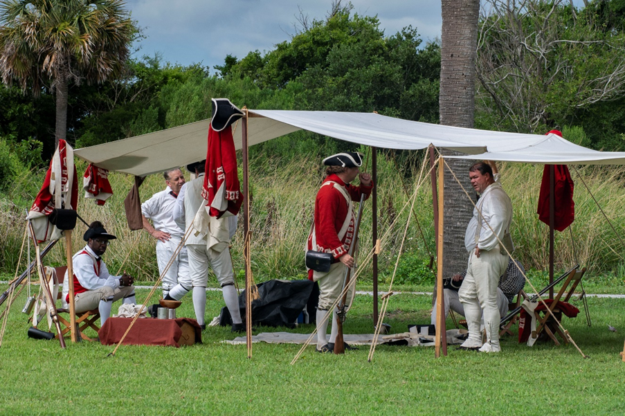 Living historians protraying British soldiers rest under a shelter Living historians protraying British soldiers rest under a shelter