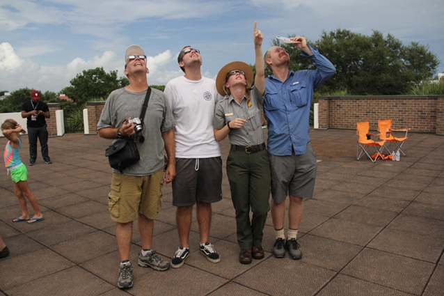 A ranger and visitors view the 2017 solar eclipse A ranger and visitors view the 2017 solar eclipse