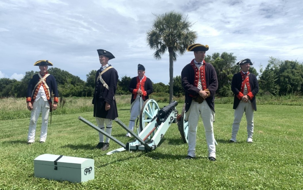 Re-enactors at Fort Moultrie Several elder male re-enactors in 18th century clothing surround a cannon.