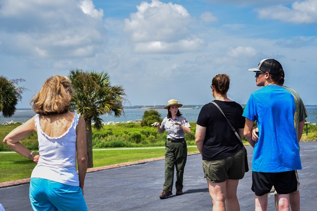 A ranger speaks with visitors on top of a battery in Fort Moultrie