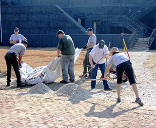 Staff spreading oyster shells at Fort Sumter