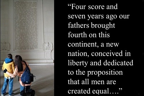 Photo of a woman and a young boy looking up at the Gettysburg Address inside the Lincoln Memorial