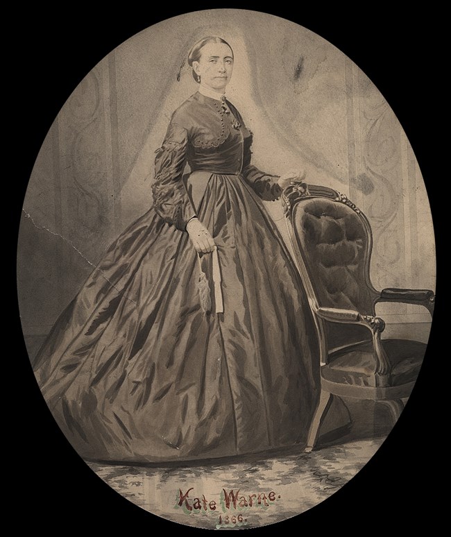 sepia-toned portarit of a woman in a large gown and labeled with the words "Kate Warne 1866"