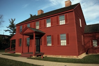 Red Colonial Style House with 5 bays, two floors and a front porch