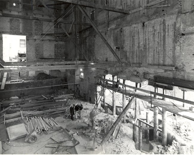 Photo view of excavated basement of Ford's surrounded by three-story brick walls