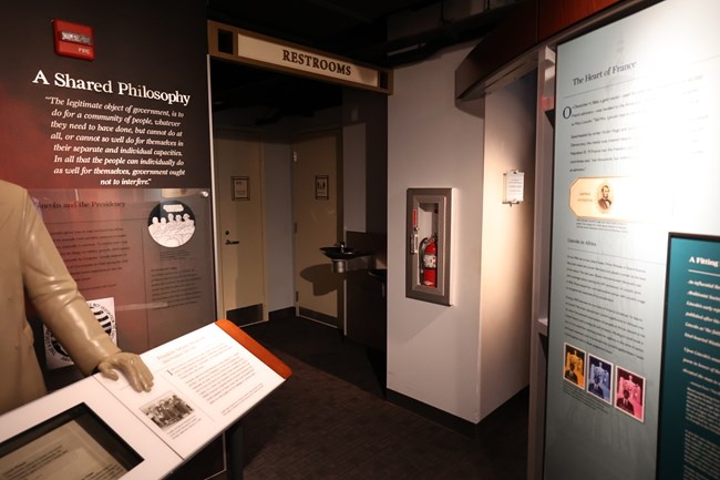 A doorway leading to two drinking fountains and the door to a family restroom.