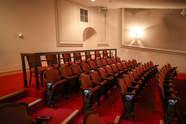 Rows of tiered seats with aisles with steps on either side.