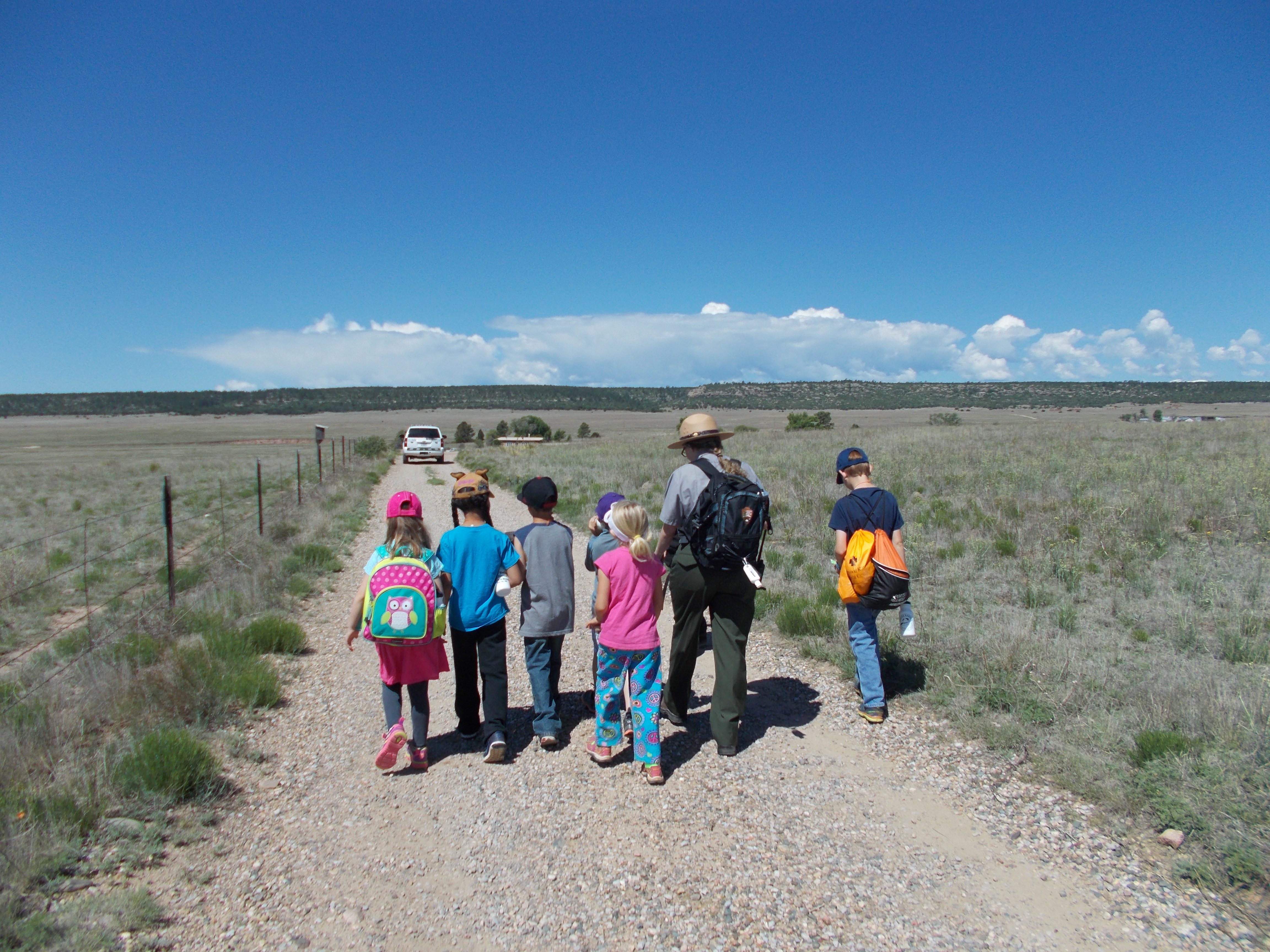 Ranger walking with students on trail