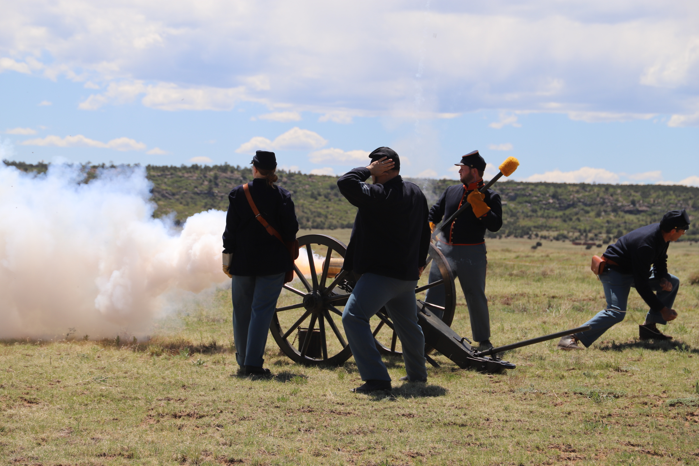 People dressed as soldiers fire a cannon