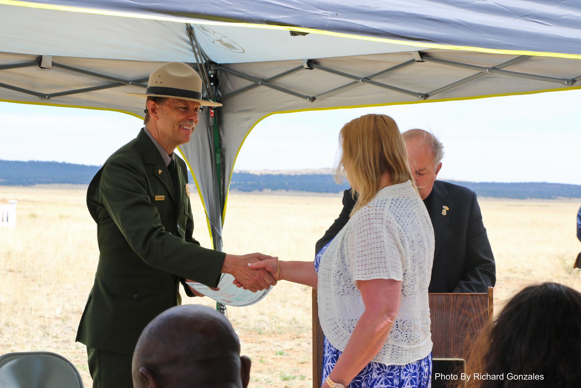 Congratulatory handshake during  2014 Naturalization Ceremony