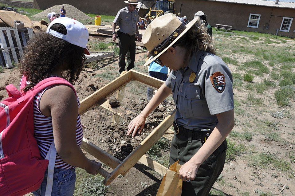 park ranger working with junior ranger